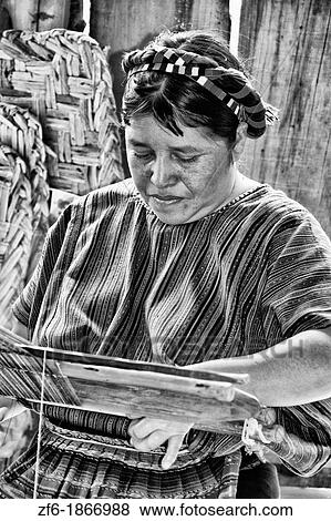 Woman at loom weaving artwork fabrics by hand in colorful dressin San Antonio on remote Lake Atitlan in Guatemala View Large Photo Image Stock Photo - Woman at loom weaving artwork fabrics by hand in colorful dressin San Antonio on remote Lake Atitlan in Guatemala. Fotosearch