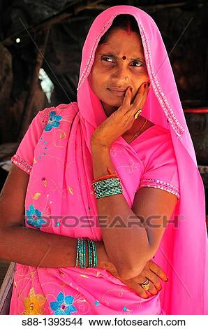 Picture - Woman at souvenir shop at Lakshman Jhula in Rishikesh. Fotosearch