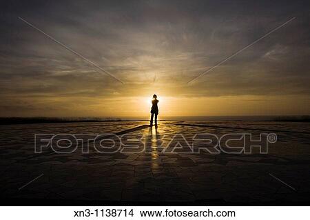 Picture - Woman at sunset in Compass Rose (Rosa de los Vientos)Next to Hercules Tower, La Coruna, A Corua, Galicia, Spain.. Fotosearch