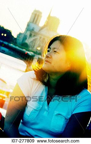 Woman at sunset in front of Notre Dame cathedral. Paris. France View Large Photo Image Stock Photo - Woman at sunset in front of Notre Dame cathedral. Paris. France. Fotosearch