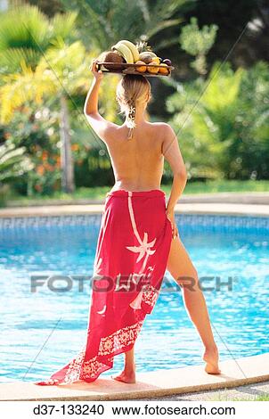 Stock Image - Woman at swimming pool. Fotosearch
