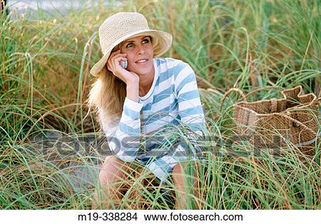 woman at the beach with cellular View Large Photo Image Picture - woman at the beach with cellular. Fotosearch