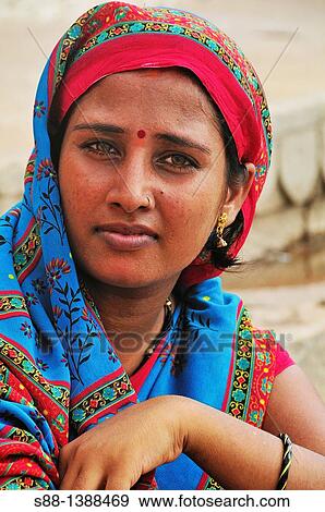 Stock Photo - Woman at the ghat by the Ganges River. Fotosearch