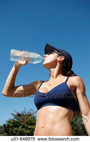 Woman athlete drinks water View Large Photo Image Stock Photo - Woman athlete drinks water. Fotosearch