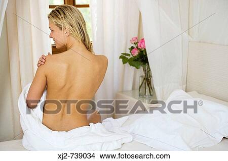 Picture - Woman back view touching her shoulders. Fotosearch