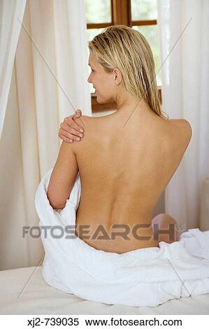 Stock Photography - Woman back view touching her shoulders. Fotosearch