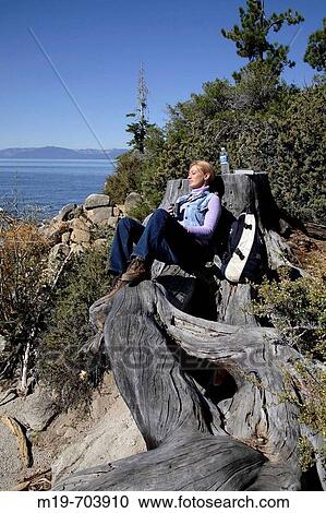 Woman backpacker relaxing in the sun View Large Photo Image Stock Image - Woman backpacker relaxing in the sun. Fotosearch