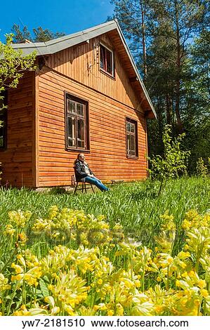 Woman basking in springtime sun outside forester's house. View Large Photo Image Stock Image - Woman basking in springtime sun outside forester's house.. Fotosearch