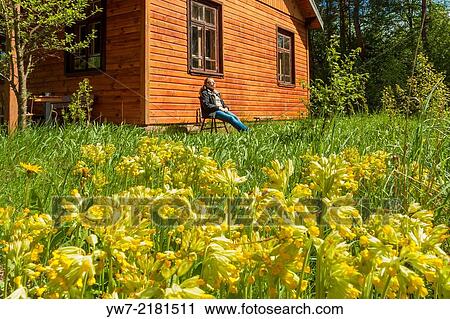 Woman basking in springtime sun outside forester's house. View Large Photo Image Stock Image - Woman basking in springtime sun outside forester's house.. Fotosearch