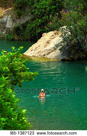 Woman bathing in a river in the countryside View Large Photo Image Stock Image - Woman bathing in a river in the countryside. Fotosearch