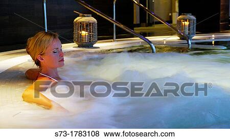Woman bathing in jacuzzi of spa center View Large Photo Image Stock Photo - Woman bathing in jacuzzi of spa center. Fotosearch