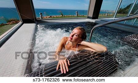 Woman bathing in jacuzzi of spa center View Large Photo Image Stock Photograph - Woman bathing in jacuzzi of spa center. Fotosearch