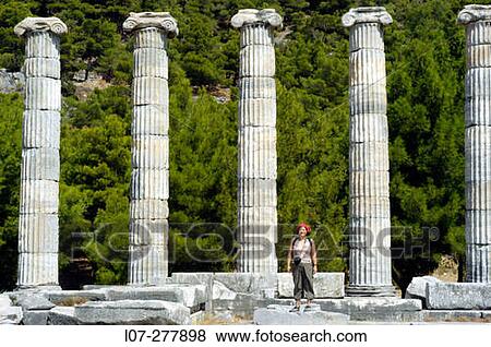 Stock Photo - Woman between standing columns of Temple of Athena Polias, ruins of Priene. Turkey. Fotosearch