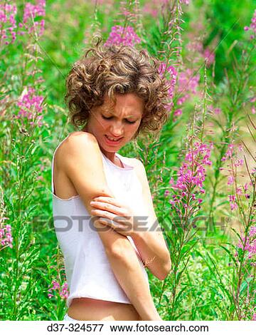 Stock Photo - Woman bitten by an insect. Fotosearch
