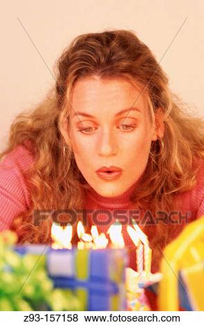 Woman blowing out Birthday candles View Large Photo Image Stock Photo - Woman blowing out Birthday candles. Fotosearch
