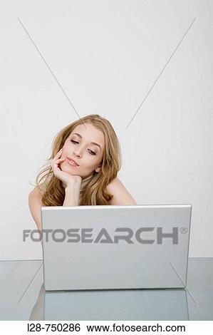 Woman bored in front of the laptop View Large Photo Image Stock Photograph - Woman bored in front of the laptop. Fotosearch