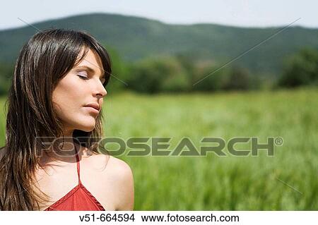 Picture - Woman breathing fresh air.. Fotosearch
