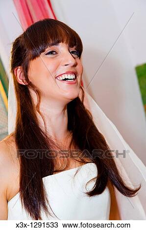 Woman bride wearing wedding dress with veil View Large Photo Image Stock Image - Woman bride wearing wedding dress with veil. Fotosearch