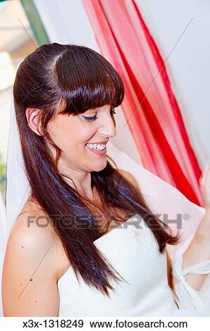 Woman bride wearing wedding dress with veil View Large Photo Image Stock Photo - Woman bride wearing wedding dress with veil. Fotosearch