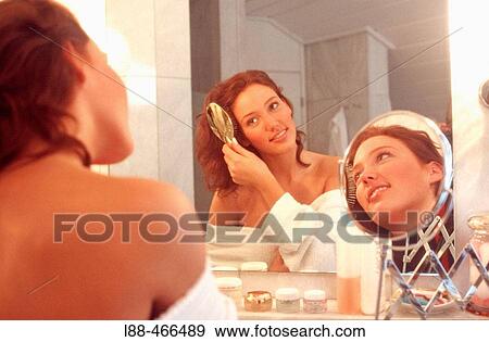 Stock Photo - Woman brushing hair. Fotosearch