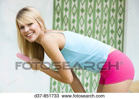 Woman brushing her hair happy View Large Photo Image Stock Image - Woman brushing her hair happy. Fotosearch