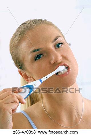 Stock Photo - woman brushing teeth. Fotosearch