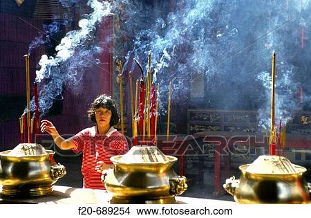 Woman burning incense at temple, Ho Chi Minh City. Vietnam View Large Photo Image Picture - Woman burning incense at temple, Ho Chi Minh City. Vietnam. Fotosearch