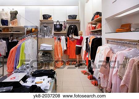Woman, buyer in fashion shop aisle. Retail outlet and fashion shop interior. Shopping. View Large Photo Image Stock Photo - Woman, buyer in fashion shop aisle. Retail outlet and fashion shop interior. Shopping.. Fotosearch