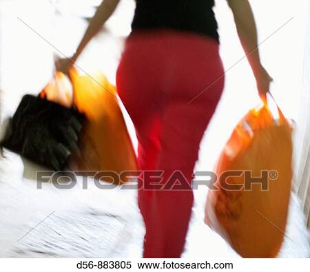 Stock Photography - woman carrying bags. Fotosearch