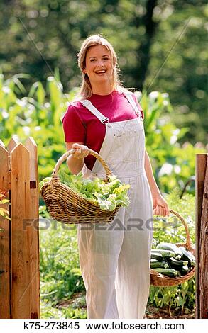 Woman carrying baskets of vegetables View Large Photo Image Stock Photography - Woman carrying baskets of vegetables. Fotosearch