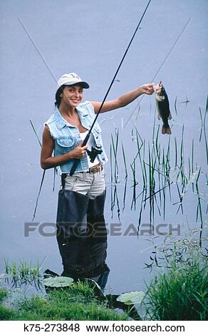 Woman catches fish View Large Photo Image Stock Photo - Woman catches fish. Fotosearch