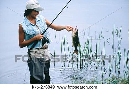 Woman catches fish View Large Photo Image Stock Photo - Woman catches fish. Fotosearch
