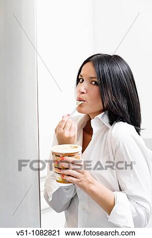 Woman caught eating icecream View Large Photo Image Stock Image - Woman caught eating icecream. Fotosearch