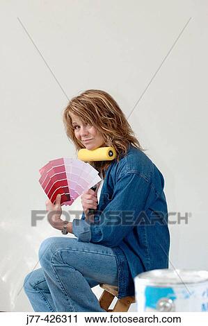 Woman choosing a colour for painting walls View Large Photo Image Stock Image - Woman choosing a colour for painting walls. Fotosearch