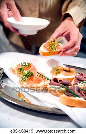 Woman choosing a smoked salmon appetizer. View Large Photo Image Stock Photo - Woman choosing a smoked salmon appetizer.. Fotosearch