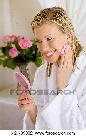 Woman cleaning her face View Large Photo Image Stock Image - Woman cleaning her face. Fotosearch