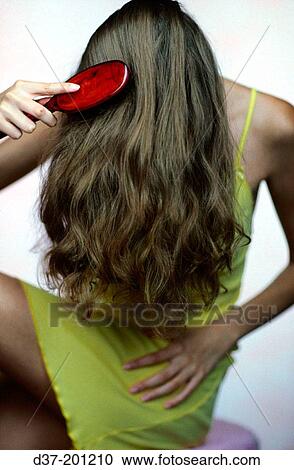 Woman combing her hair View Large Photo Image Stock Image - Woman combing her hair. Fotosearch
