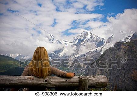 Woman comtemplating Monch mountain Murren Switzerland View Large Photo Image Stock Photograph - Woman comtemplating Monch mountain Murren Switzerland. Fotosearch