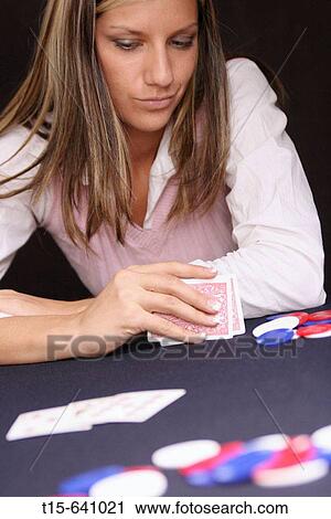 Woman contemplating in a card game View Large Photo Image Stock Image - Woman contemplating in a card game. Fotosearch