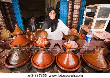 Woman cooking in tajine pots, Guezoula near Safi, Morocco. View Large Photo Image Stock Photography - Woman cooking in tajine pots, Guezoula near Safi, Morocco.. Fotosearch