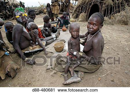 Woman cooking. Mursi village. Omo valley. South Ethiopia. View Large Photo Image Stock Image - Woman cooking. Mursi village. Omo valley. South Ethiopia.. Fotosearch