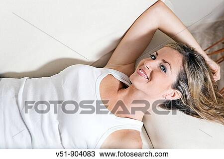 Woman, couch, home, happy, leisure, sofa, smile, smiling View Large Photo Image Stock Image - Woman, couch, home, happy, leisure, sofa, smile, smiling. Fotosearch