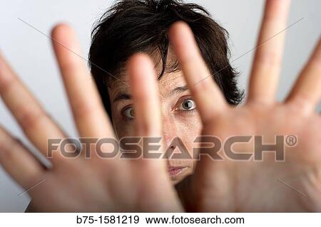 Woman covering camera with her hands View Large Photo Image Stock Photo - Woman covering camera with her hands. Fotosearch