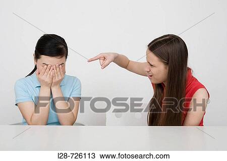 Woman covering face, the other woman angry View Large Photo Image Stock Image - Woman covering face, the other woman angry. Fotosearch