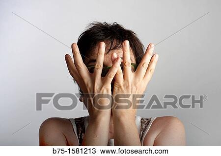 Woman covering her face View Large Photo Image Stock Image - Woman covering her face. Fotosearch