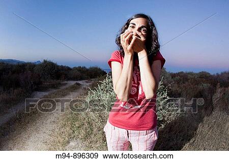 Stock Photo - Woman covering her mouth. Fotosearch