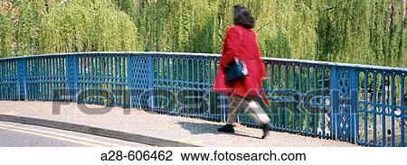 Woman crossing bridge View Large Photo Image Stock Image - Woman crossing bridge. Fotosearch