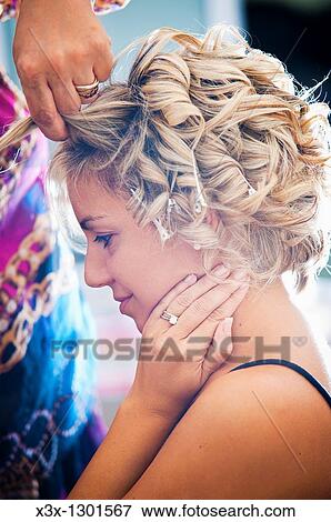 Woman curling hair View Large Photo Image Stock Photo - Woman curling hair. Fotosearch