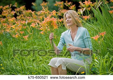 woman cutting a bouquet of lillies View Large Photo Image Stock Image - woman cutting a bouquet of lillies. Fotosearch