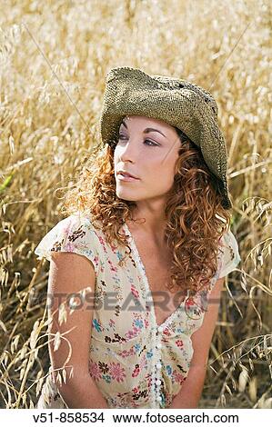 Picture - Woman daydraming in the countryside. Fotosearch